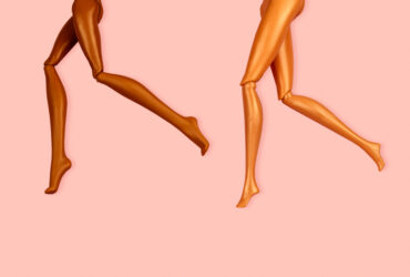 legs of plastic dolls with different skin color on pink background, hair removal and skin care concept